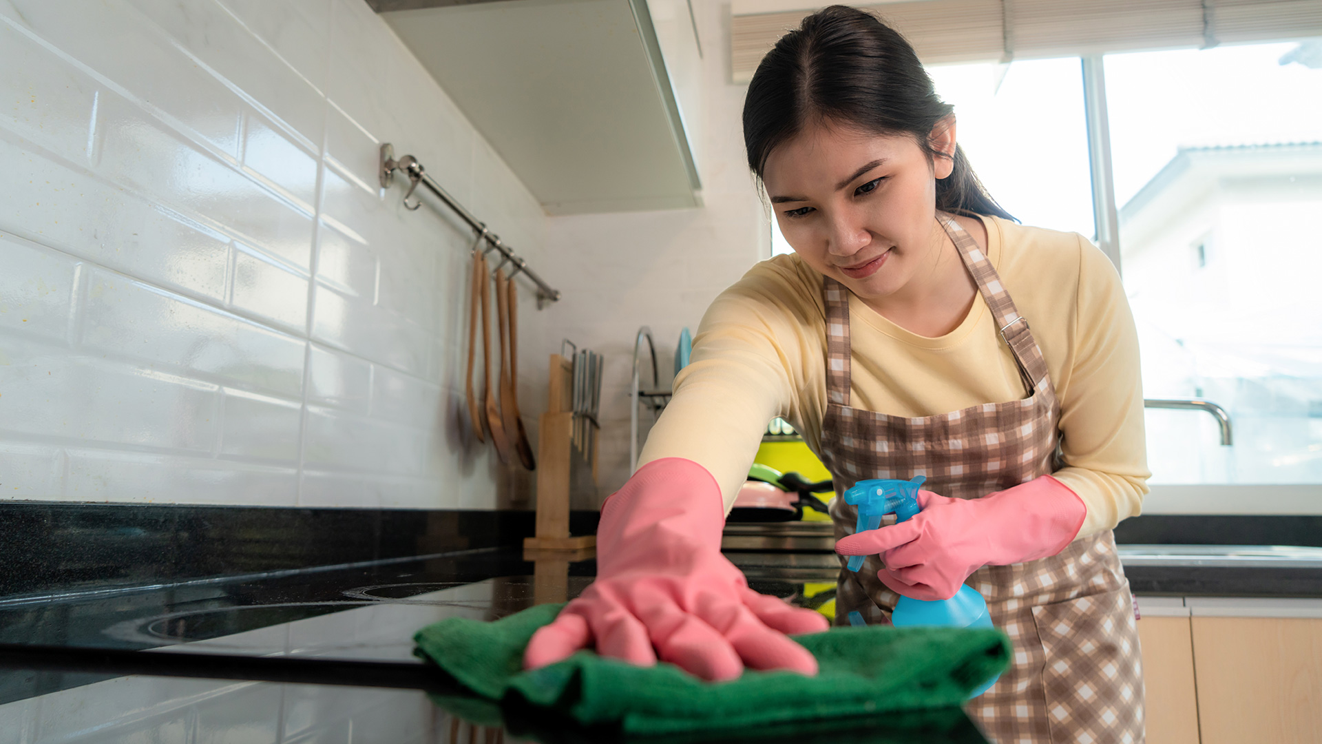 maid in pattaya wiping kitchen