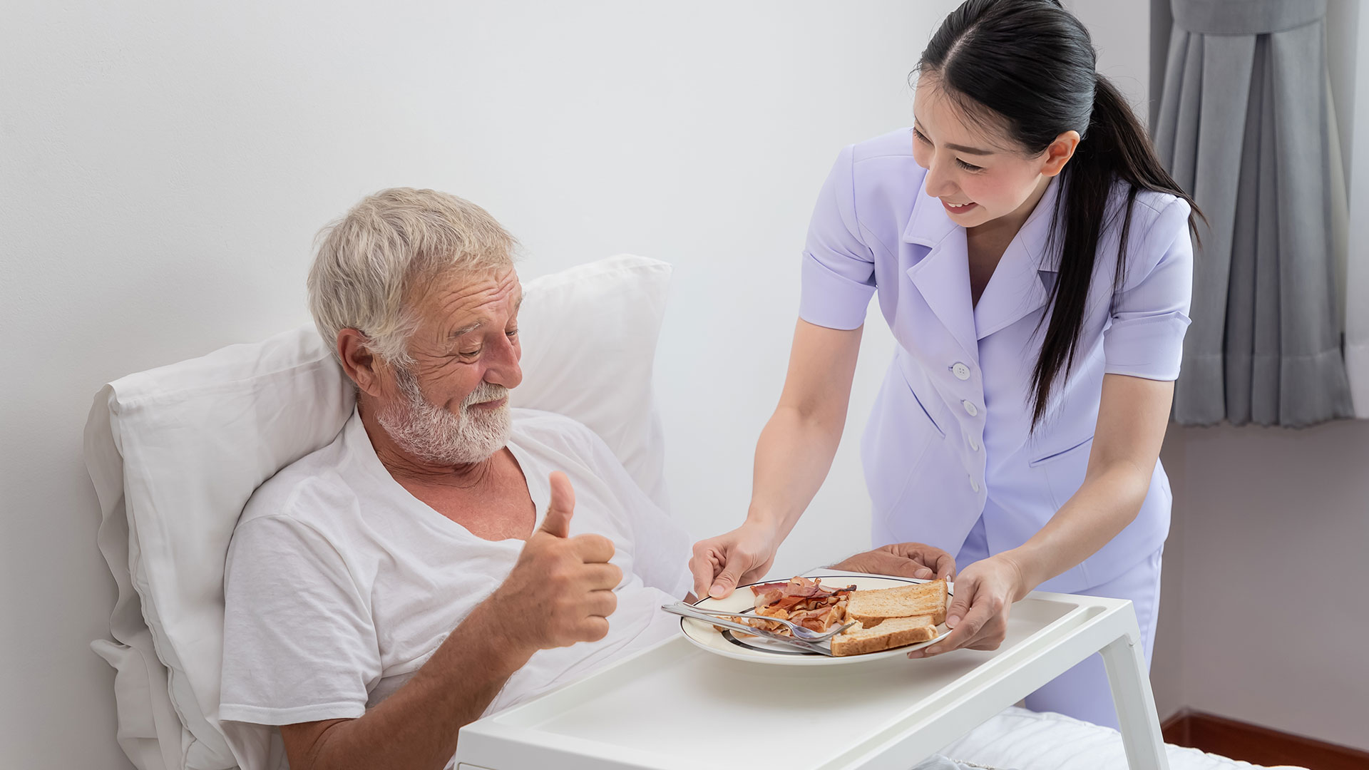 elder people taking meal with nanny